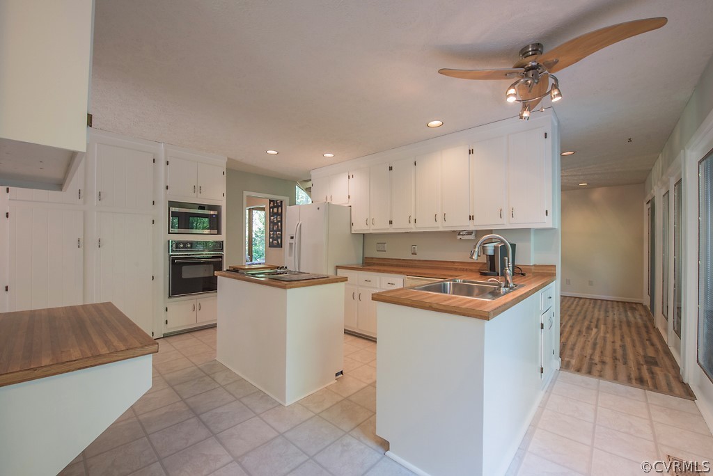 14200 Long Gate Road Midlothian, VA 23112 - Photo 12 of 27 a kitchen with stainless steel appliances granite countertop a sink and a refrigerator