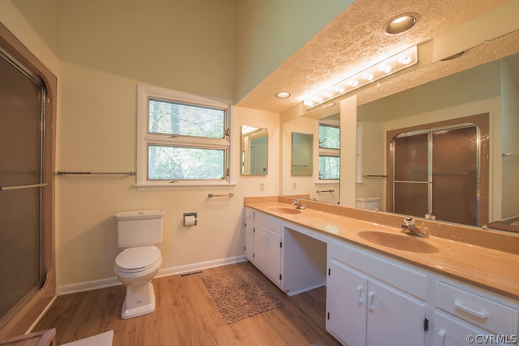 14200 Long Gate Road Midlothian, VA 23112 - Photo 18 of 27 a bathroom with a granite countertop toilet a sink and a large mirror