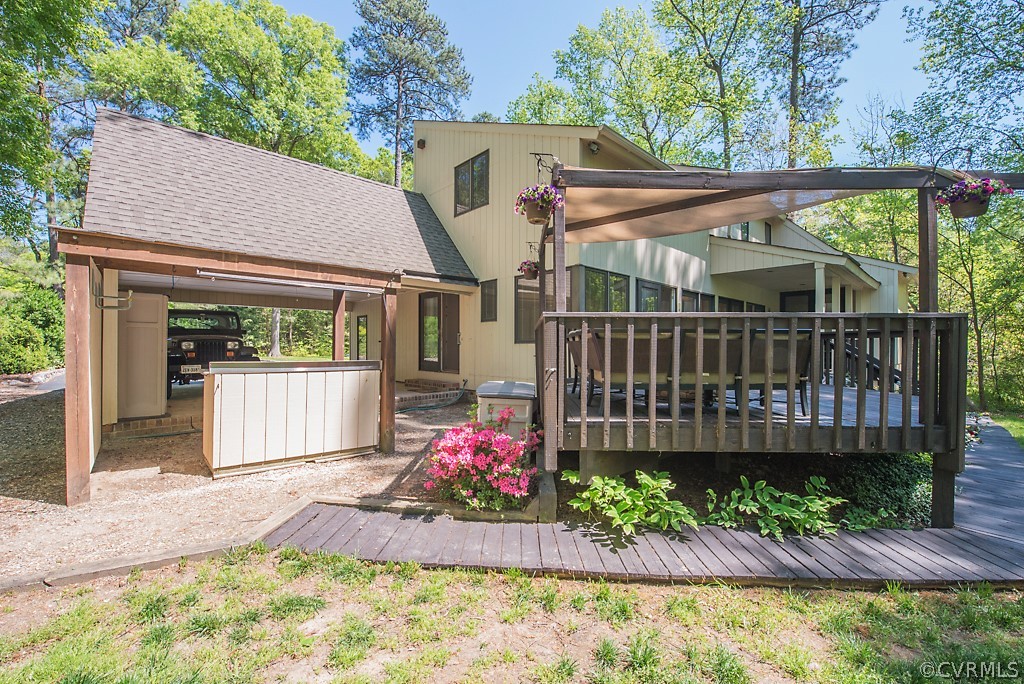 14200 Long Gate Road Midlothian, VA 23112 - Photo 25 of 27 a view of a backyard with a small deck and a garden