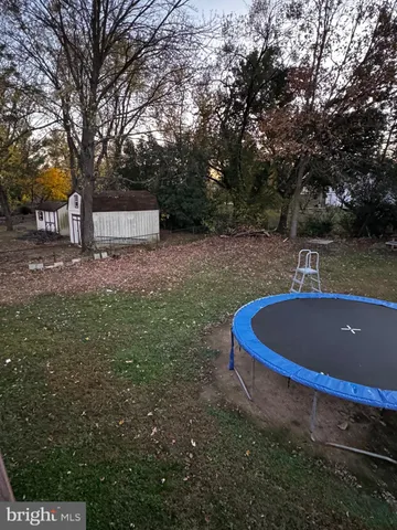 a view of a backyard with large trees