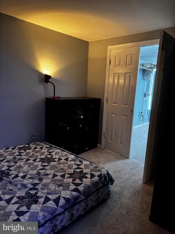 a bedroom with a bed and a mirror