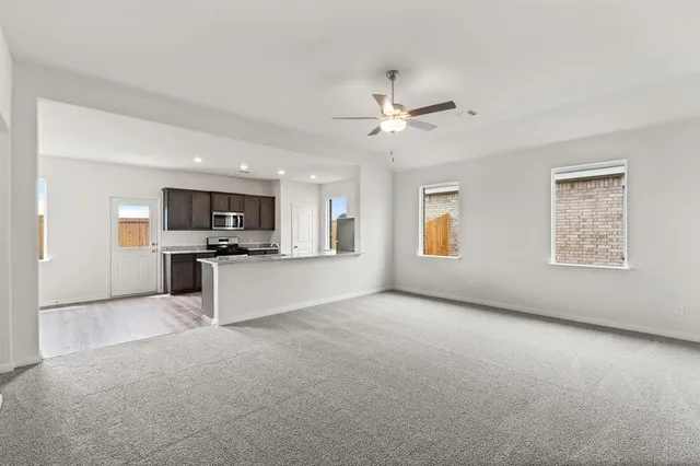 a view of kitchen with cabinets and window