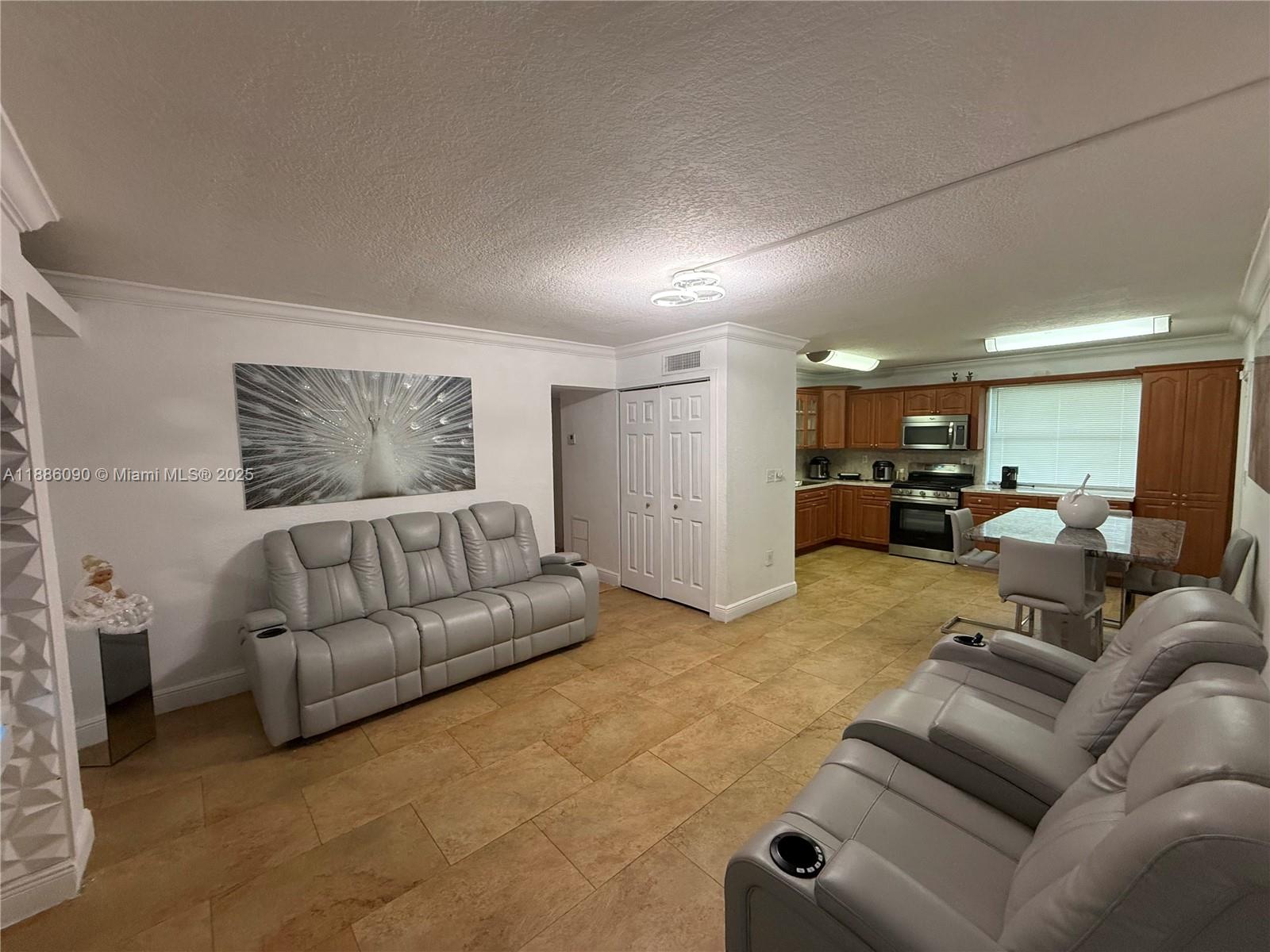 4300 Southwest 67th Avenue, Unit 23 Miami, FL 33155 - Photo 5 of 8 a living room with furniture and a large window