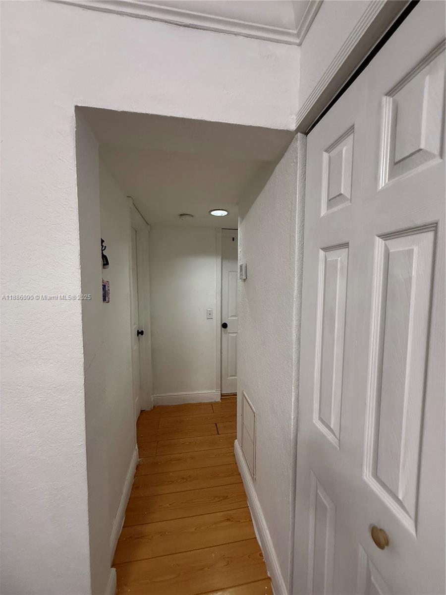 4300 Southwest 67th Avenue, Unit 23 Miami, FL 33155 - Photo 6 of 8 a view of a hallway with wooden floor and staircase