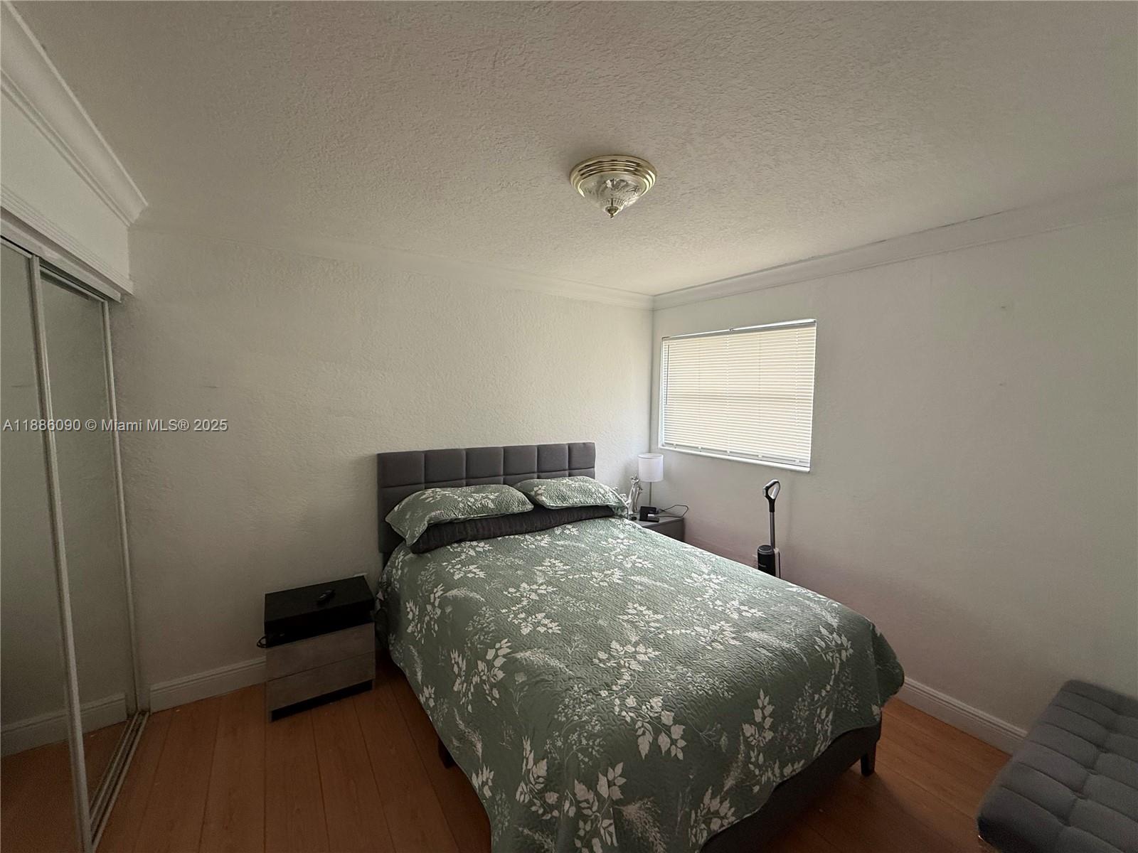 4300 Southwest 67th Avenue, Unit 23 Miami, FL 33155 - Photo 7 of 8 a bedroom with a bed and window