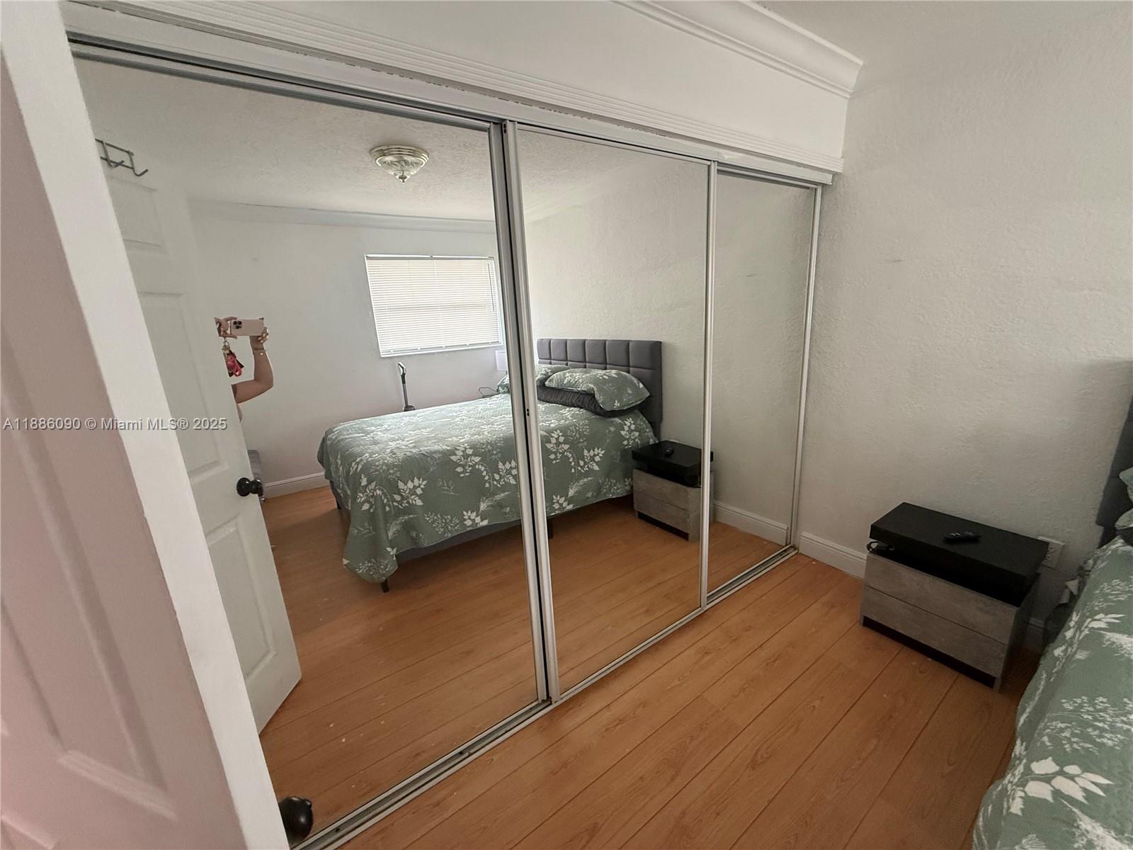 4300 Southwest 67th Avenue, Unit 23 Miami, FL 33155 - Photo 8 of 8 a bedroom with a bed and a chair