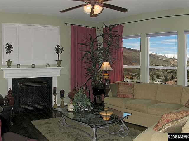 4871 Grousecreek Court Reno, NV 89519 - Photo 4 of 9 a living room with furniture a fireplace and a large window