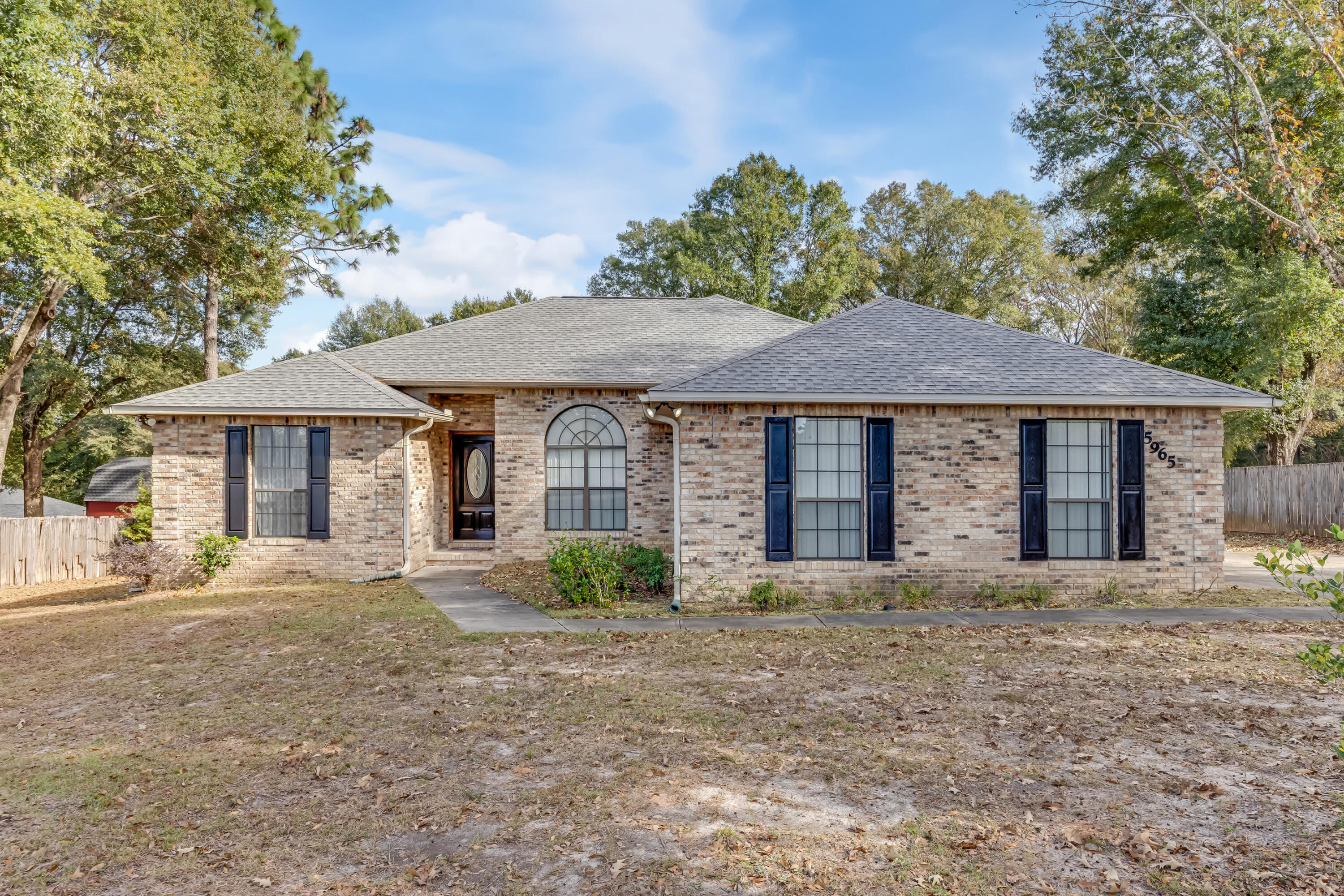 5965 Oak Hill Road Crestview, FL 32536 - Photo 1 of 44 a front view of a house with a garden