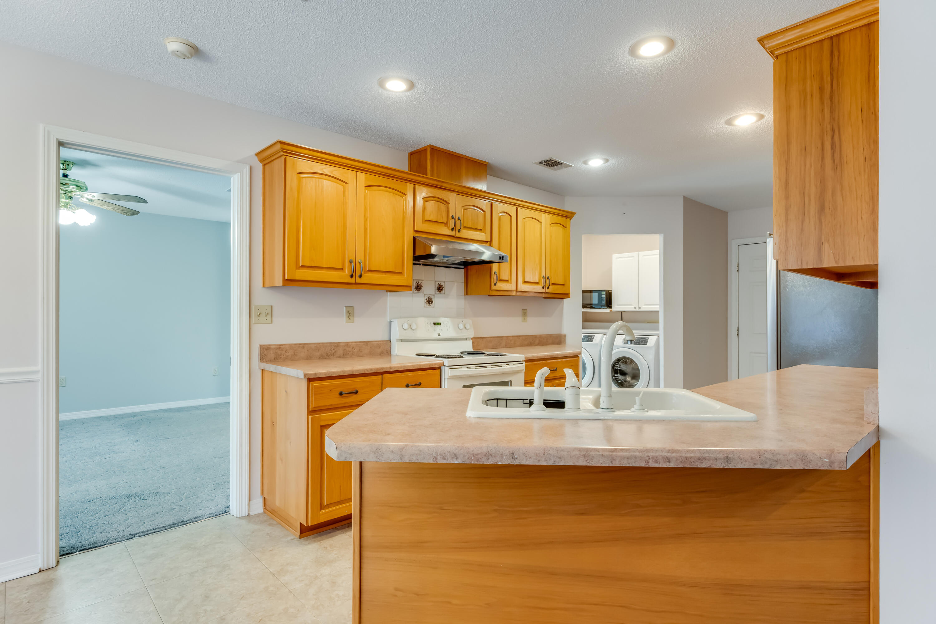 5965 Oak Hill Road Crestview, FL 32536 - Photo 11 of 44 a kitchen with stainless steel appliances granite countertop a sink stove and refrigerator