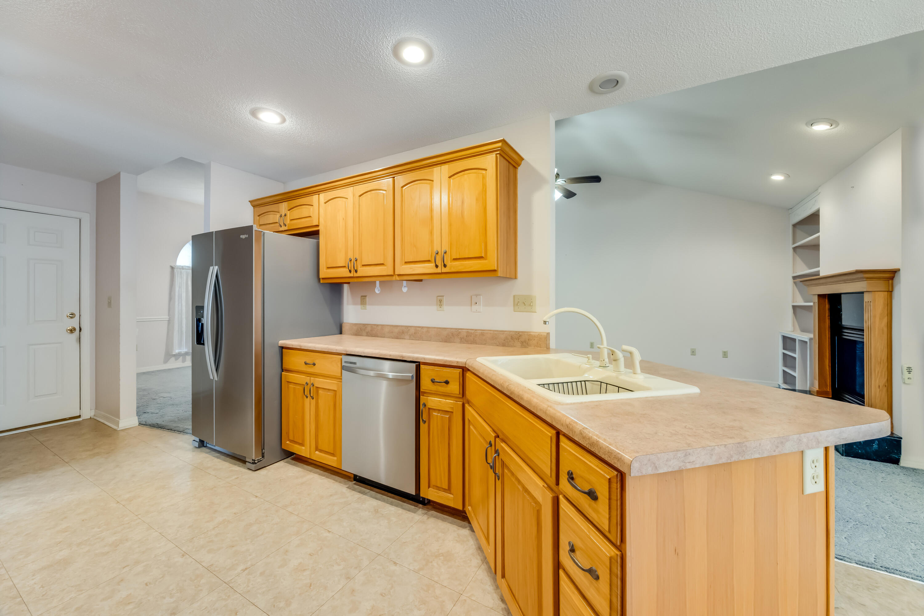 5965 Oak Hill Road Crestview, FL 32536 - Photo 12 of 44 a kitchen with stainless steel appliances granite countertop a sink and refrigerator