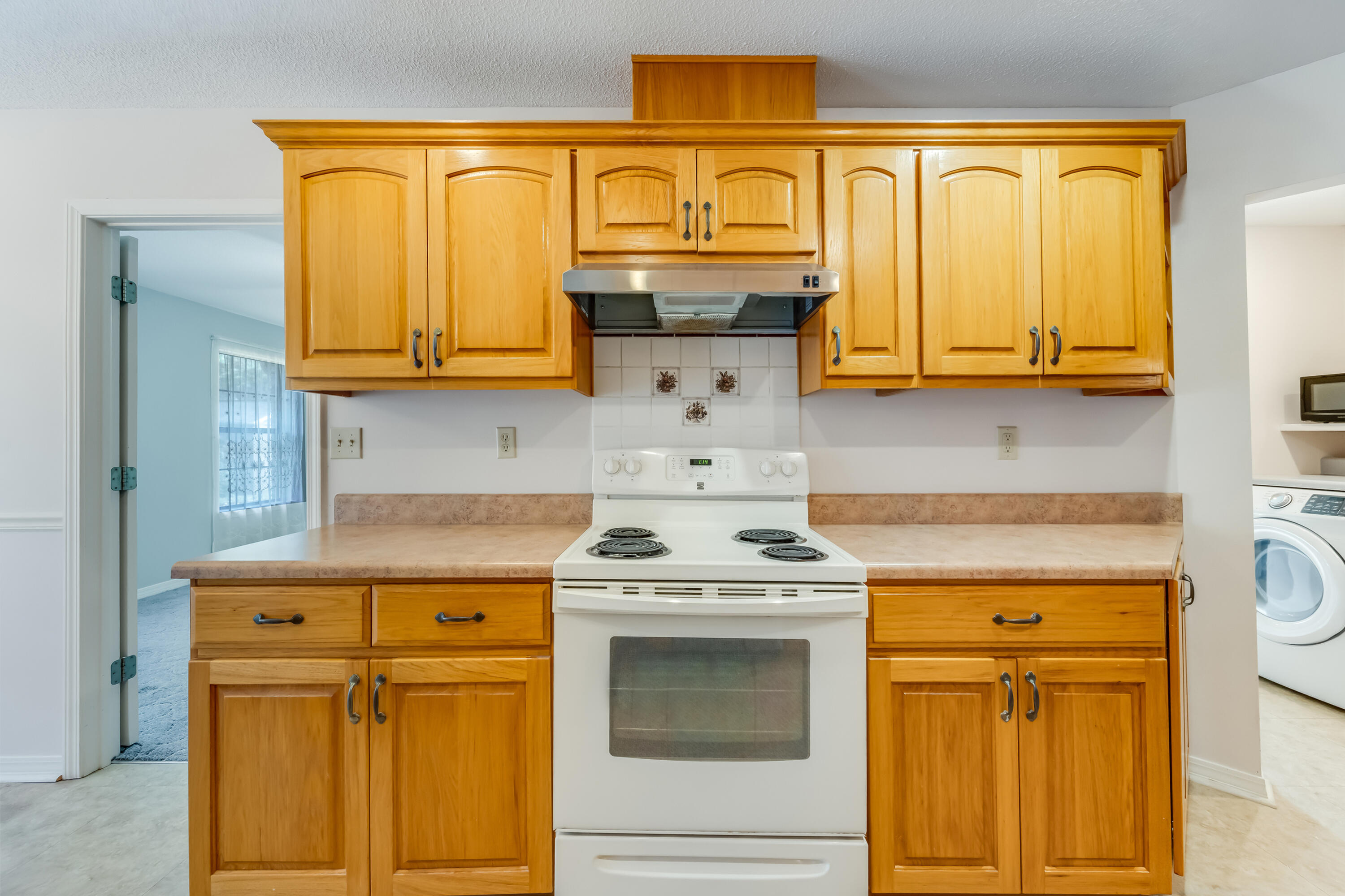 5965 Oak Hill Road Crestview, FL 32536 - Photo 13 of 44 a kitchen with granite countertop cabinets stainless steel appliances and wooden cabinets