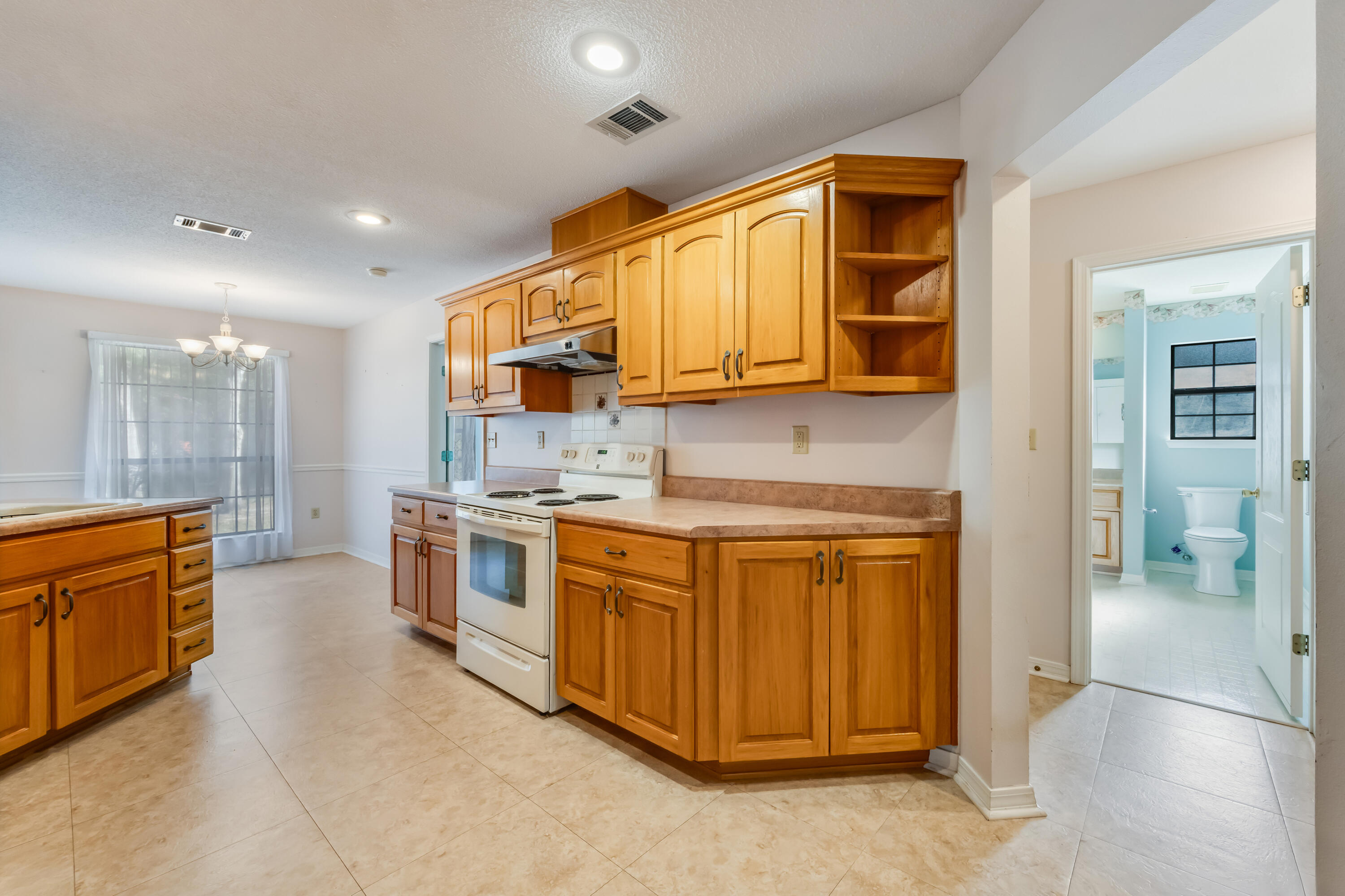 5965 Oak Hill Road Crestview, FL 32536 - Photo 14 of 44 a kitchen with stainless steel appliances granite countertop a stove and a sink
