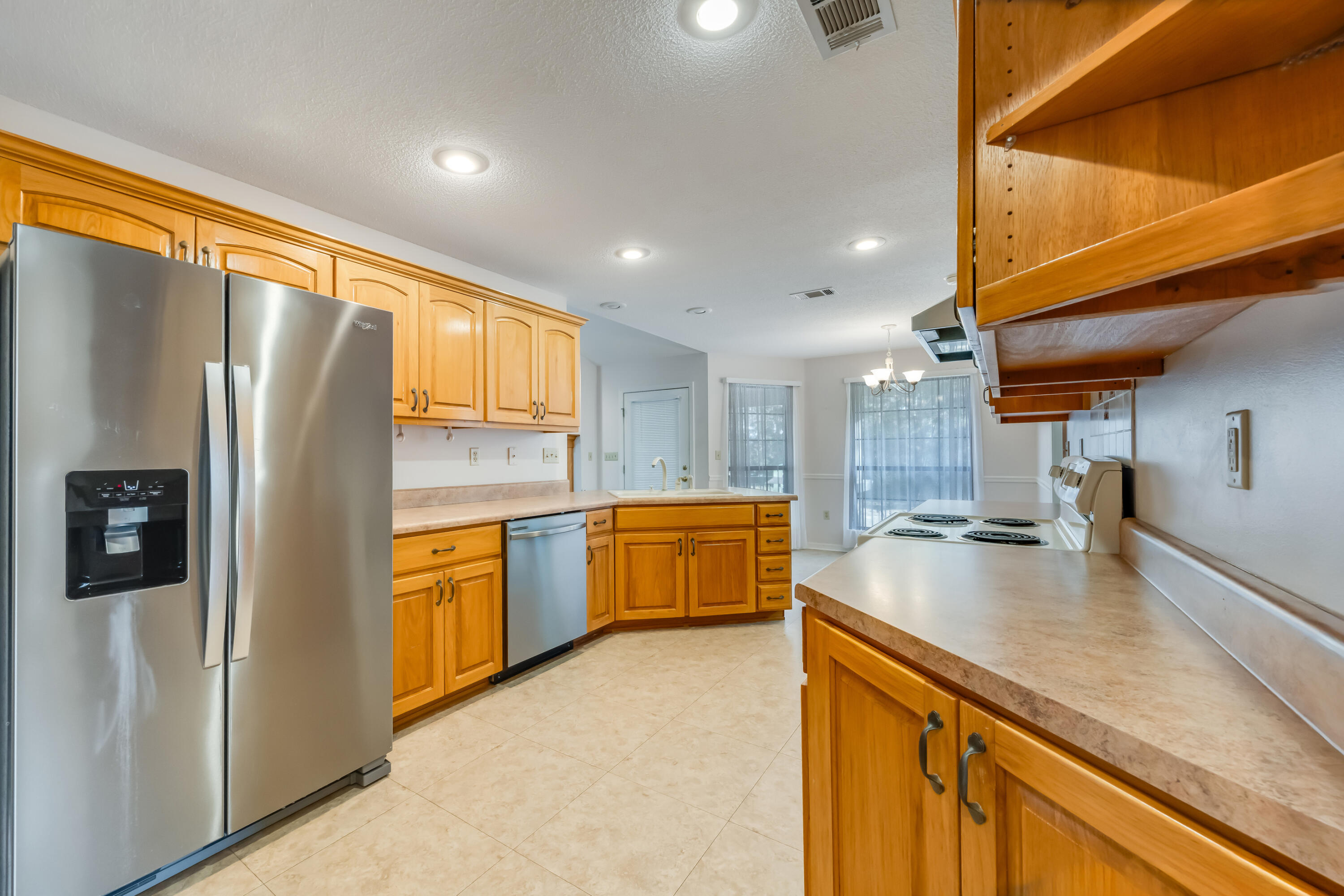 5965 Oak Hill Road Crestview, FL 32536 - Photo 15 of 44 a kitchen with stainless steel appliances granite countertop a refrigerator a sink and a stove