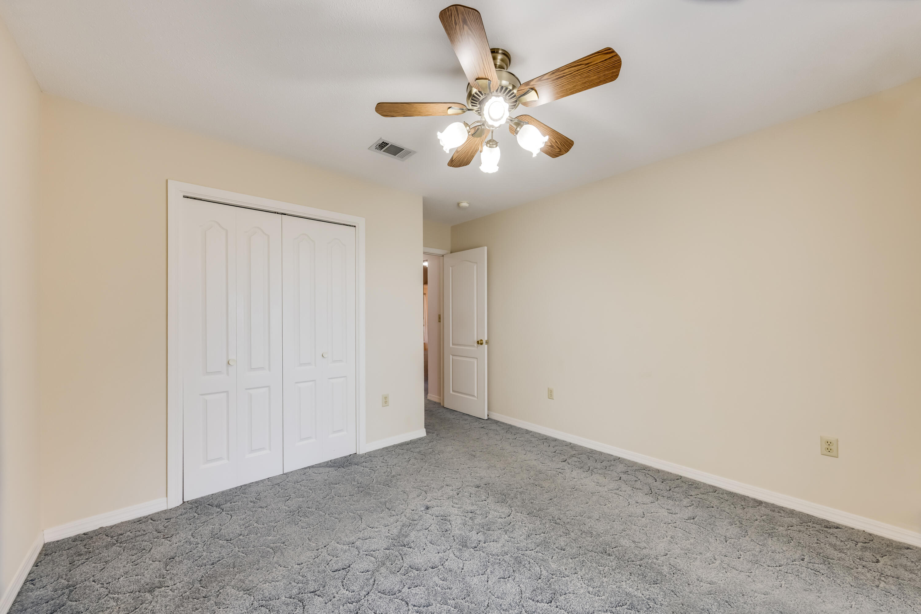 5965 Oak Hill Road Crestview, FL 32536 - Photo 27 of 44 an empty room with a chandelier fan and a window