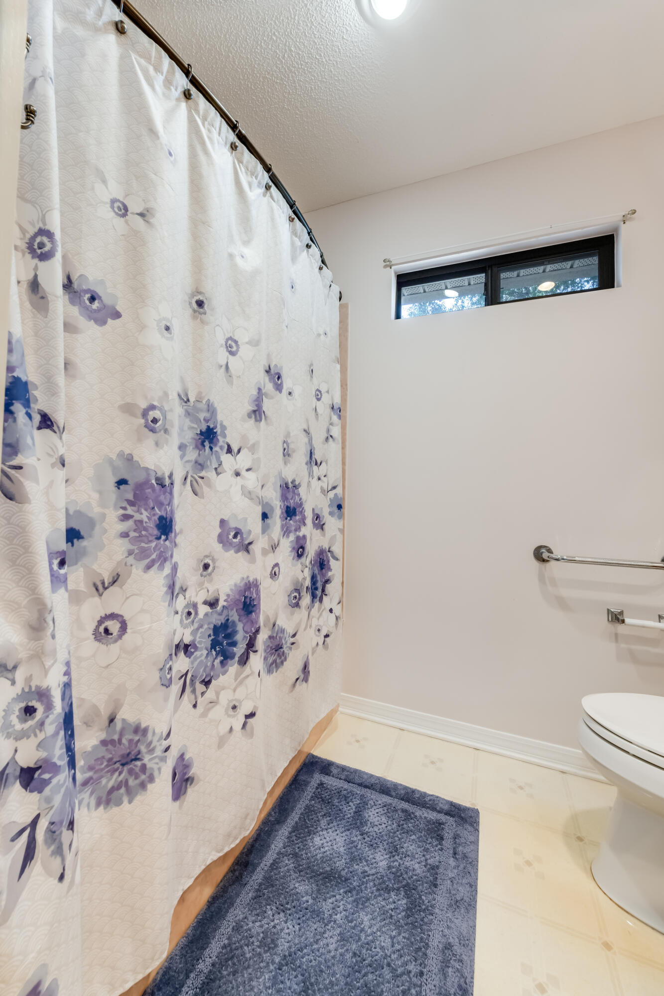 5965 Oak Hill Road Crestview, FL 32536 - Photo 29 of 44 a bathroom with a toilet and a shower curtain