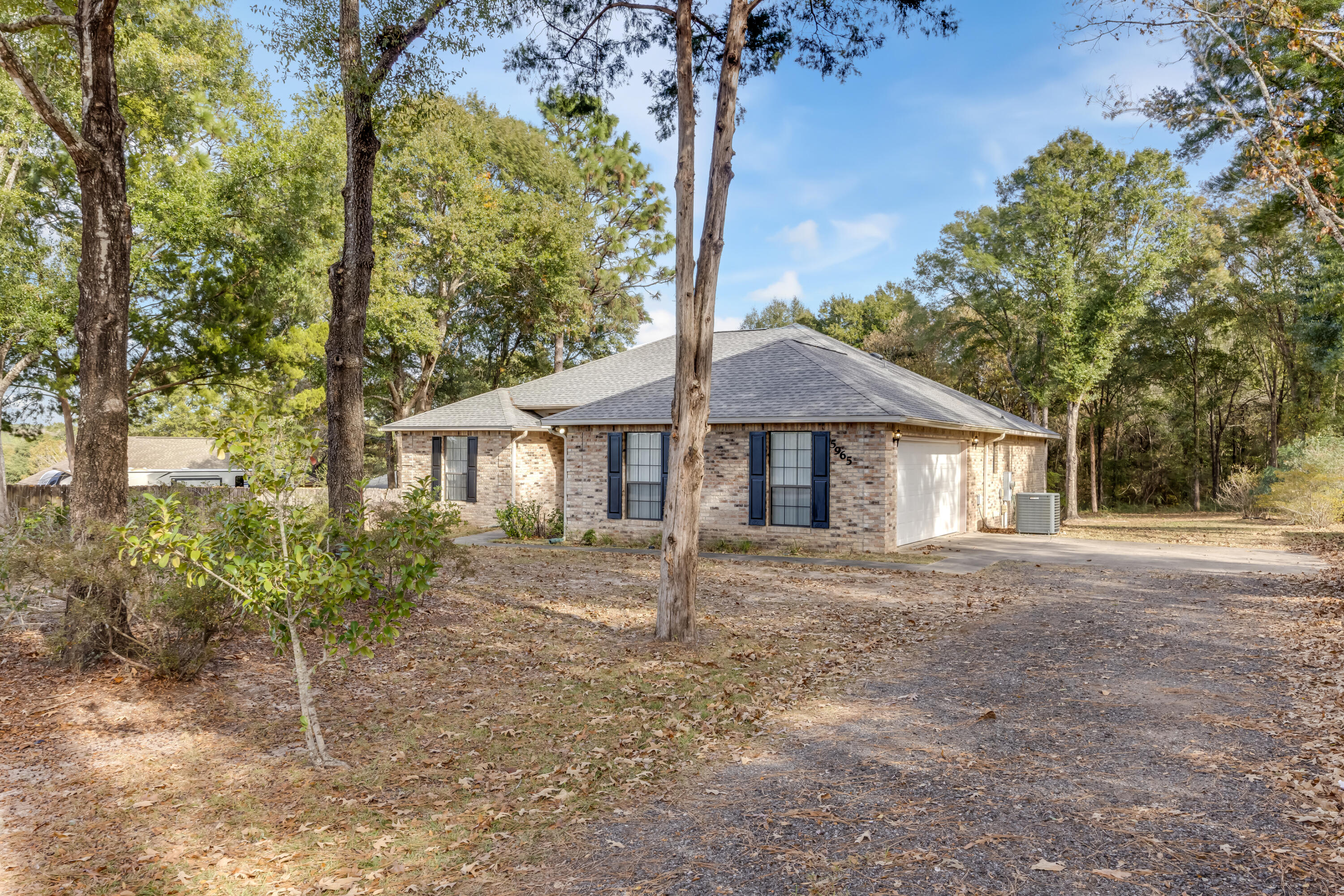 5965 Oak Hill Road Crestview, FL 32536 - Photo 3 of 44 a house with trees in the background