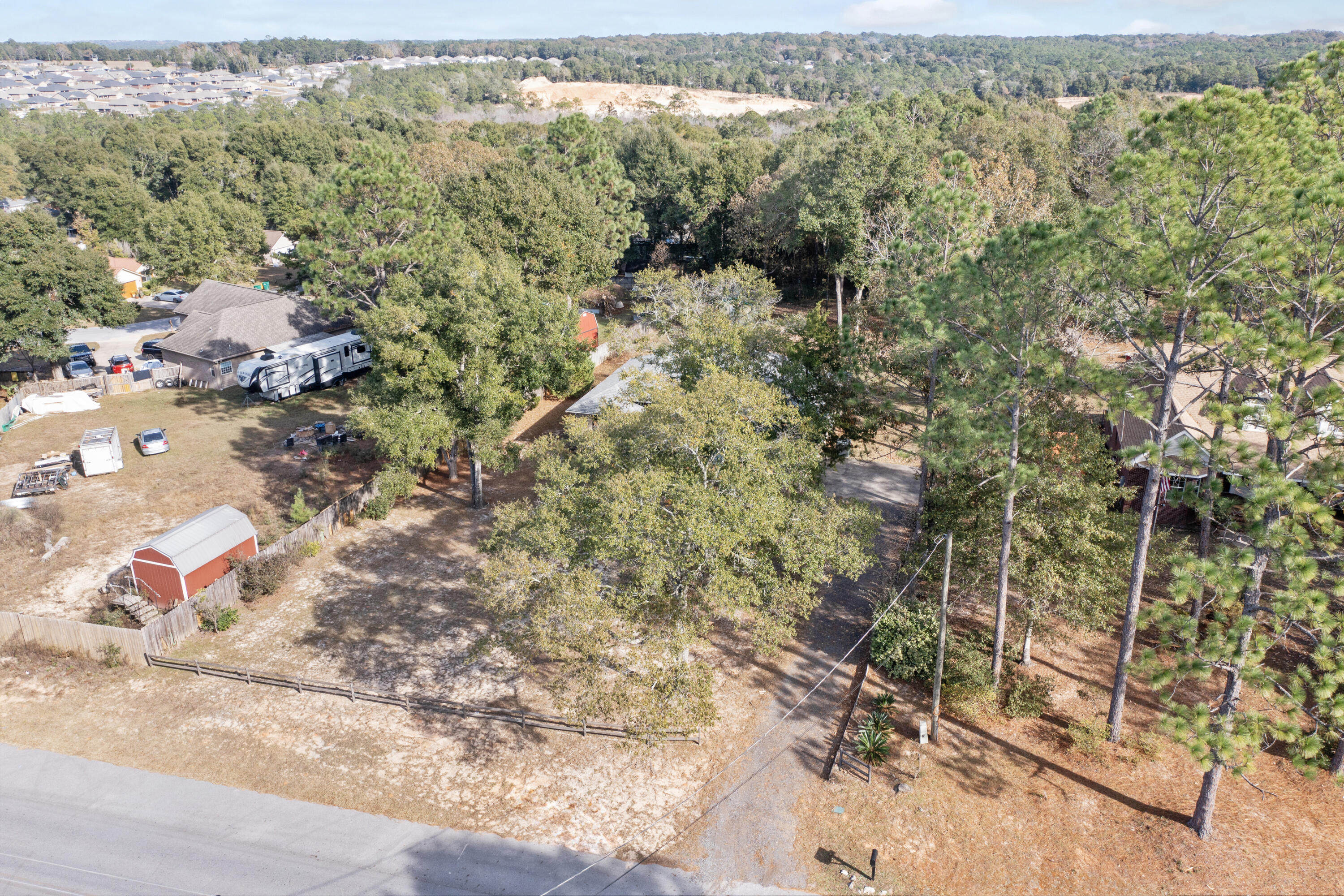 5965 Oak Hill Road Crestview, FL 32536 - Photo 41 of 44 a view of a forest with a yard