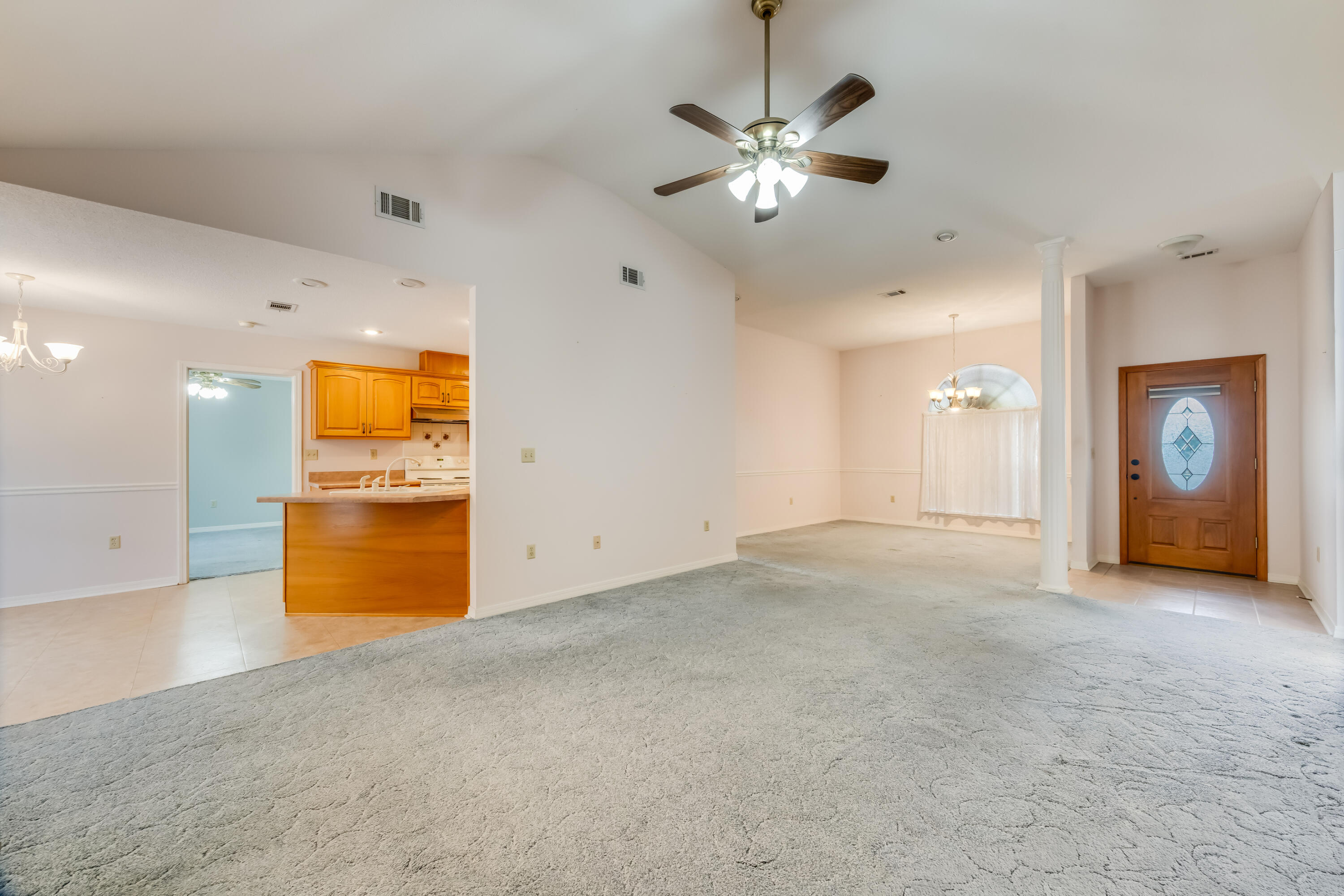 5965 Oak Hill Road Crestview, FL 32536 - Photo 6 of 44 an empty room with chandelier fan and a bathroom