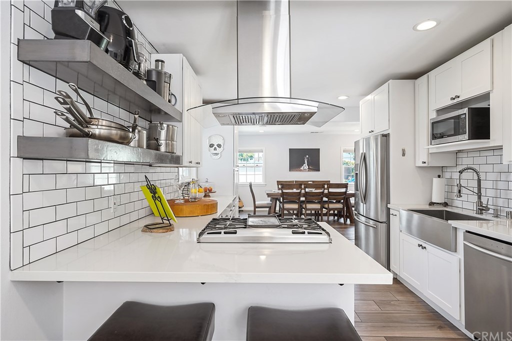 14709 Bodger Avenue Hawthorne, CA 90250 - Photo 5 of 24 a kitchen with stainless steel appliances kitchen island granite countertop a sink and a stove