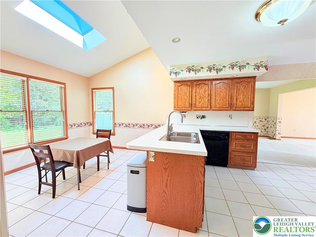 4165 Alder Road Bethlehem, PA 18020 - Photo 12 of 42 a kitchen with a stove a sink a dining table and chairs
