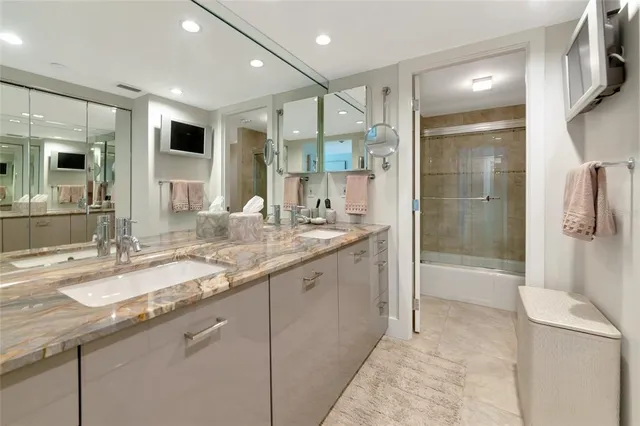 a bathroom with a granite countertop sink mirror and double