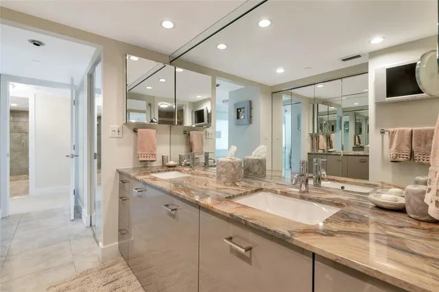 a bathroom with a double vanity sink and a mirror
