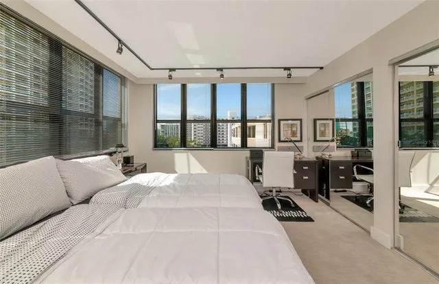 a living room with furniture large window and flat screen tv