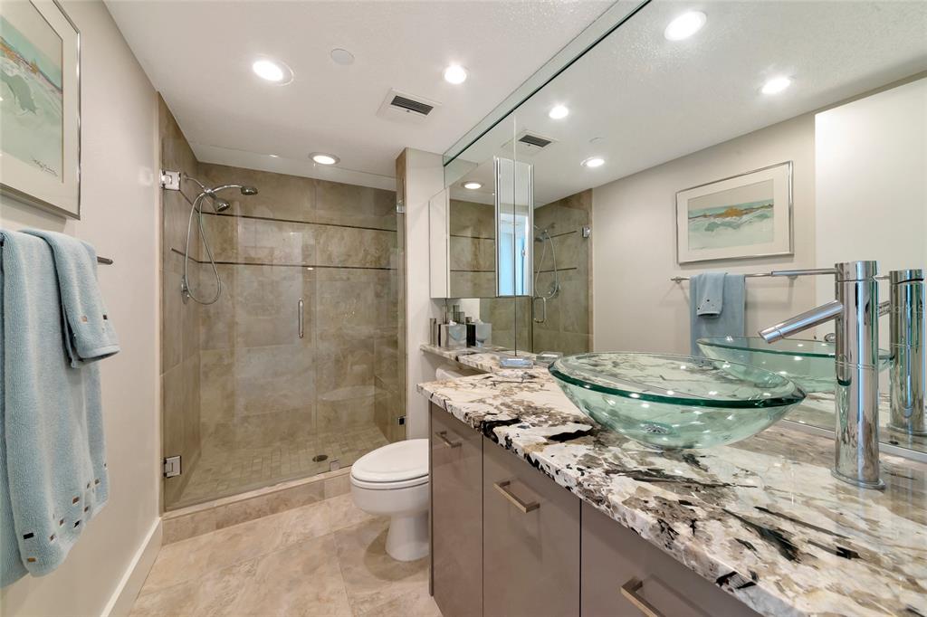 101 Sunset Drive, Unit PH3 Sarasota, FL 34236 - Photo 22 of 47 a bathroom with a granite countertop sink a toilet and shower