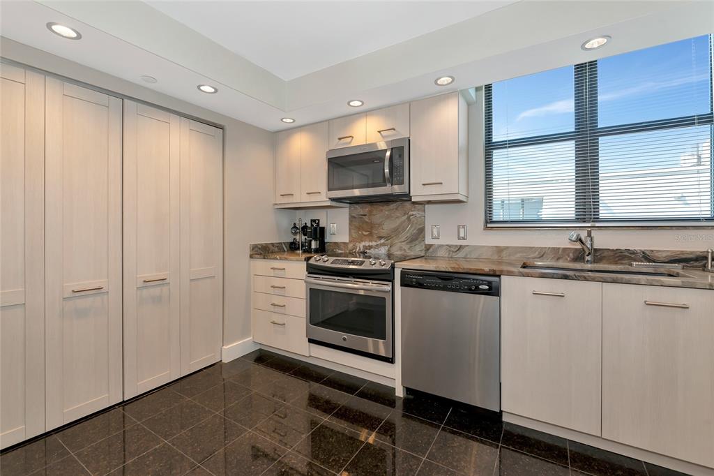 101 Sunset Drive, Unit PH3 Sarasota, FL 34236 - Photo 24 of 47 a kitchen with stainless steel appliances granite countertop a stove a sink and a microwave