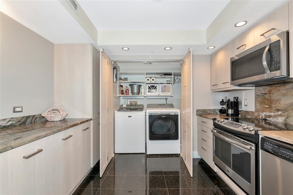 101 Sunset Drive, Unit PH3 Sarasota, FL 34236 - Photo 27 of 47 a kitchen with stainless steel appliances granite countertop a stove a microwave and a refrigerator