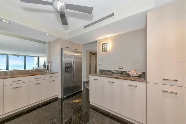 a spacious bathroom with a granite countertop sink a toilet and a mirror