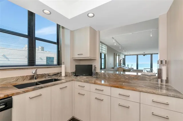 a kitchen with granite countertop a sink and a window
