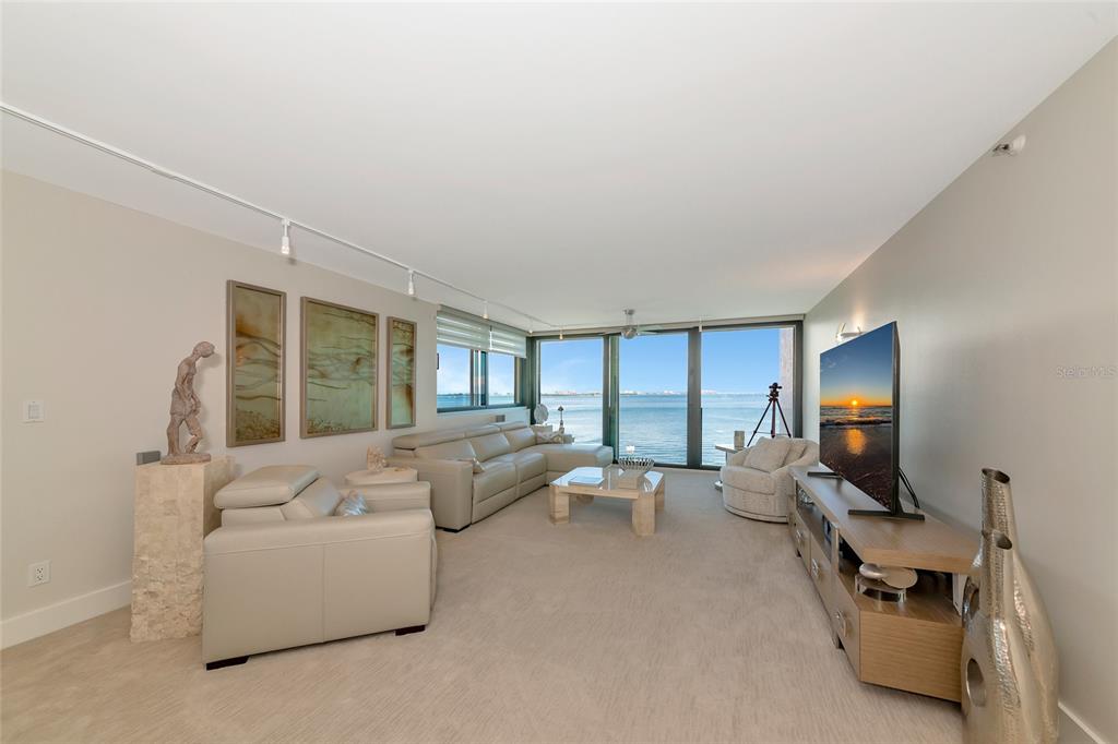 101 Sunset Drive, Unit PH3 Sarasota, FL 34236 - Photo 7 of 47 a living room with furniture and a flat screen tv