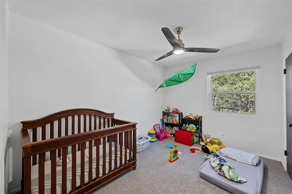 a bedroom with furniture and a baby crib