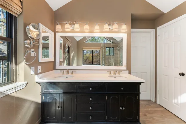 a spacious bathroom with a bathtub and large window