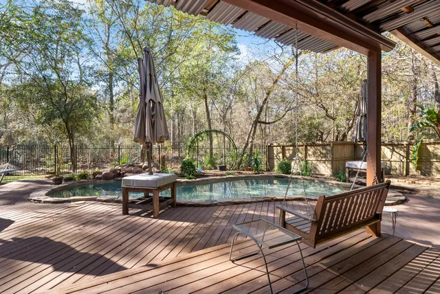 a view of an empty room and chandelier fan