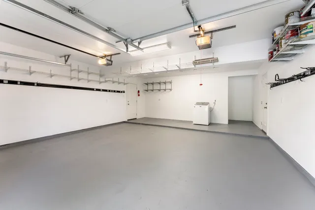 a white house with a large window and wooden fence