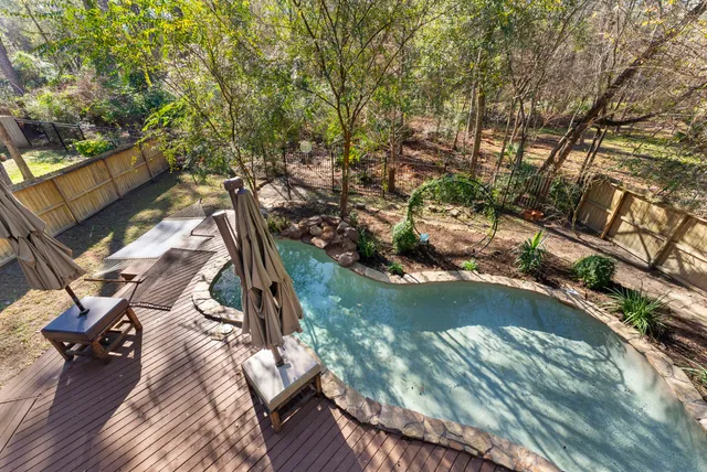 a balcony with wooden floor and outdoor seating
