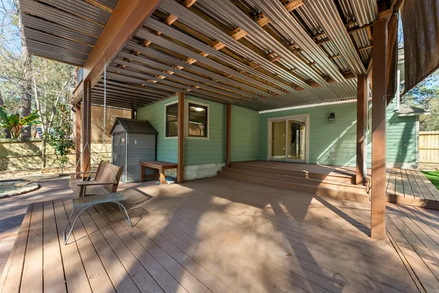 a view of a house with backyard porch and sitting area