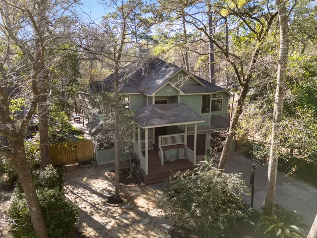 a view of a swimming pool with a table and chairs under an umbrella