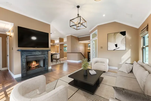 a living room with furniture a fireplace and a flat screen tv