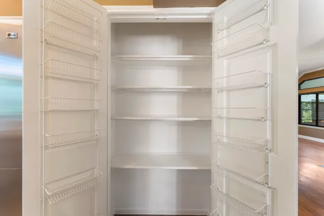 a large kitchen with kitchen island a large window and a sink