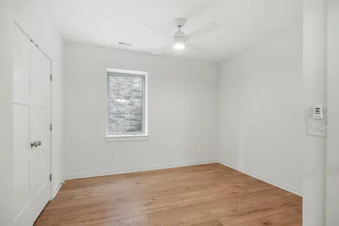 wooden floor in an empty room with a window