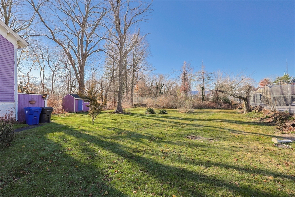 69 Cutler Street Warren, RI 02885 - Photo 11 of 13 a garden view with tall trees