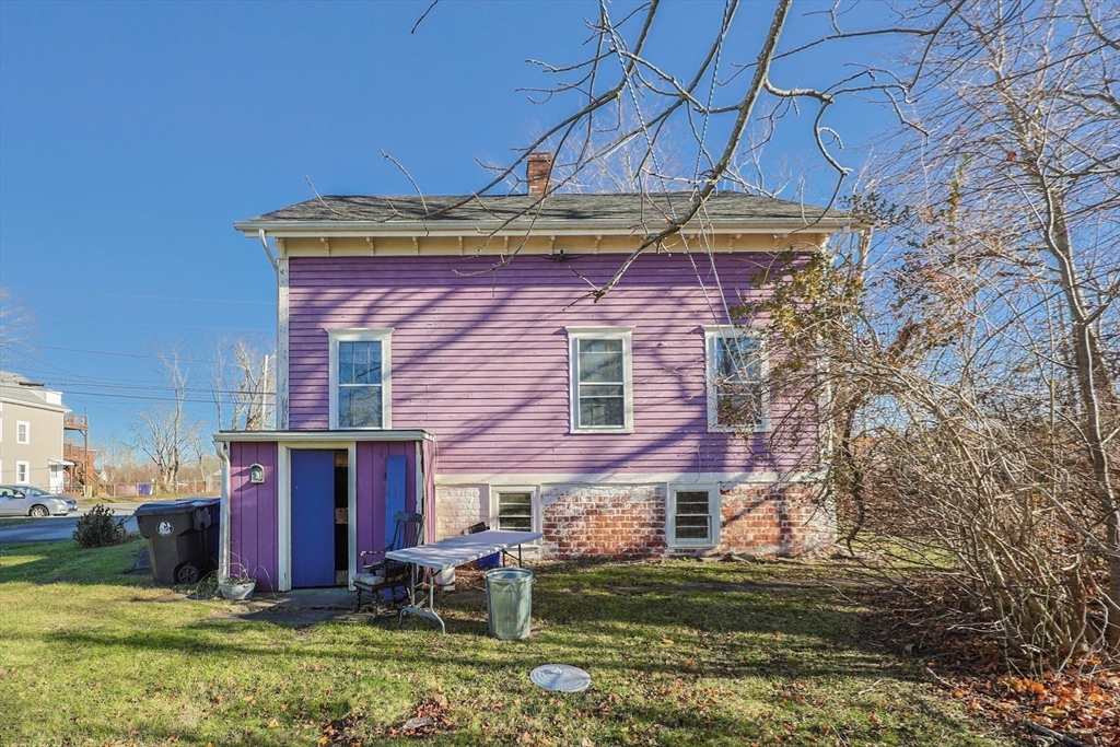 69 Cutler Street Warren, RI 02885 - Photo 8 of 13 a view of a brick house with a yard