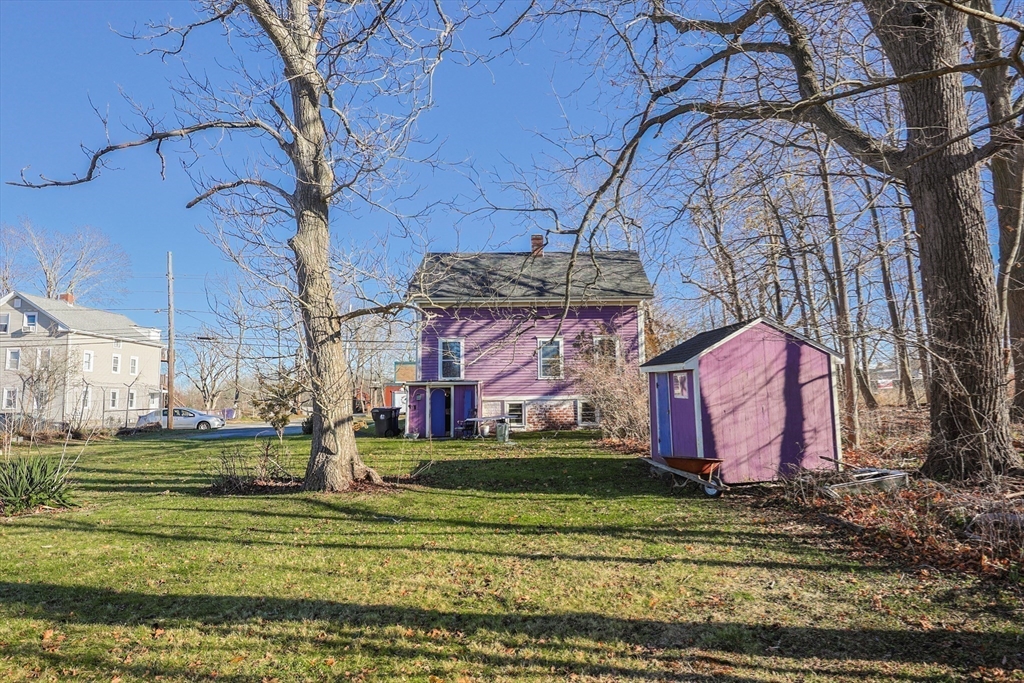 69 Cutler Street Warren, RI 02885 - Photo 9 of 13 a front view of a building with a yard