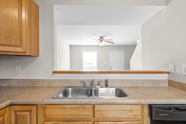 a kitchen with sink and cabinets