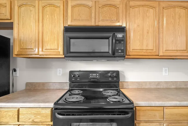 a stove top oven sitting inside of a kitchen