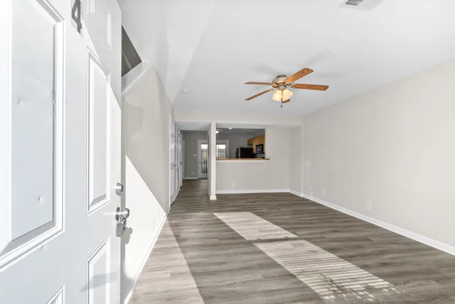 a view of entryway and hall with wooden floor