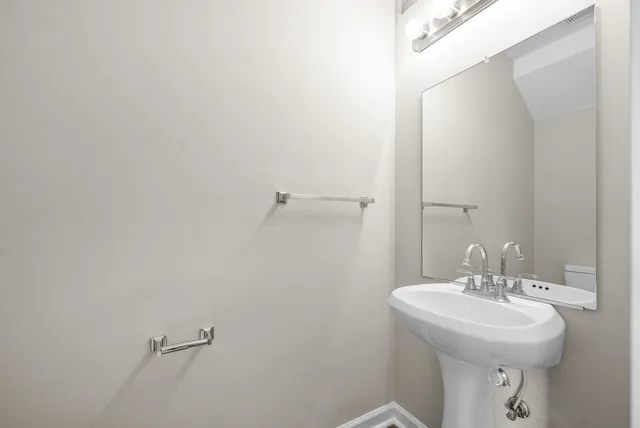 a bathroom with a sink and mirror
